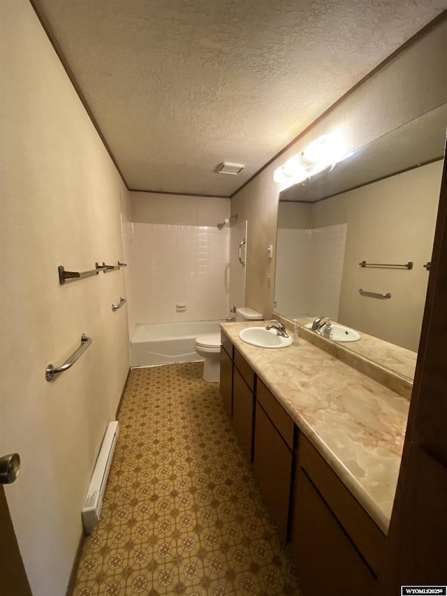 bathroom with vanity, baseboard heating, a textured ceiling, toilet, and shower / bathtub combination