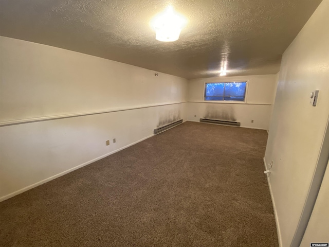 finished basement with carpet flooring, a textured ceiling, a baseboard heating unit, and baseboards