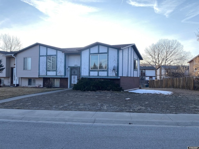 view of front of home featuring fence