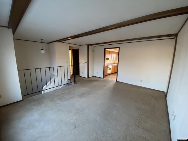 unfurnished room featuring beam ceiling