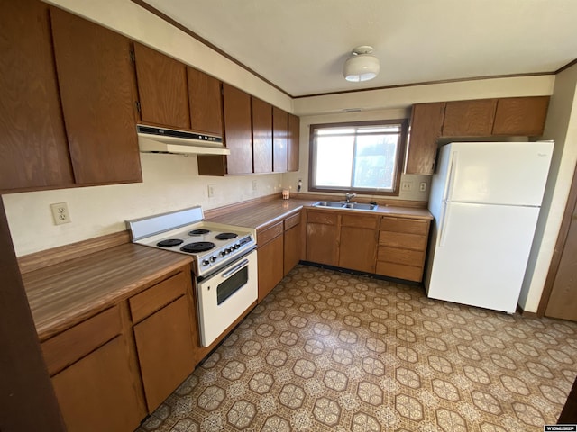 kitchen with ornamental molding, under cabinet range hood, a sink, white appliances, and light floors