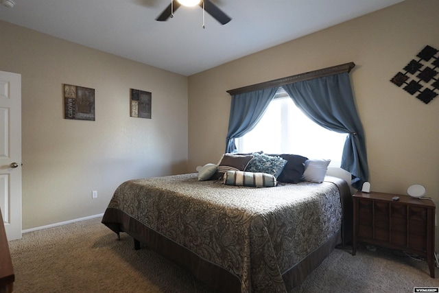 bedroom with a ceiling fan, baseboards, and carpet floors