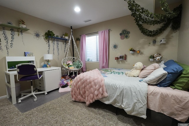 bedroom with visible vents, finished concrete flooring, and baseboards