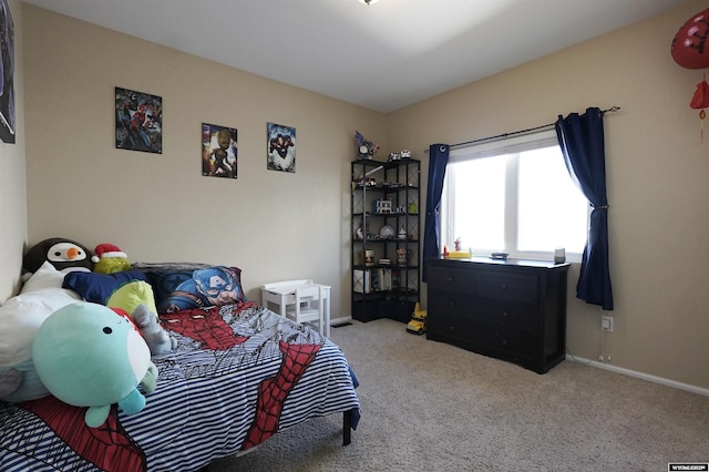 carpeted bedroom featuring baseboards