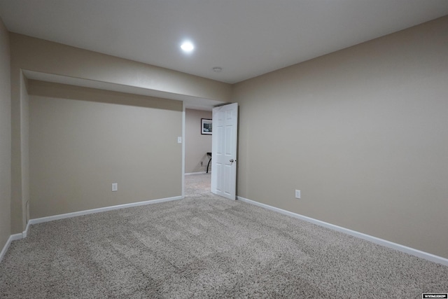 spare room featuring carpet flooring and baseboards