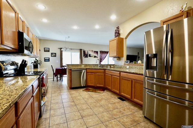 kitchen with a sink, appliances with stainless steel finishes, recessed lighting, and light tile patterned floors