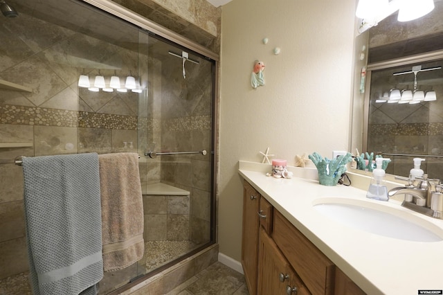 full bathroom with a stall shower and vanity