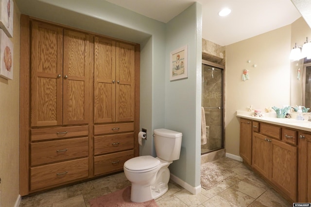 full bath with a shower stall, toilet, vanity, and baseboards