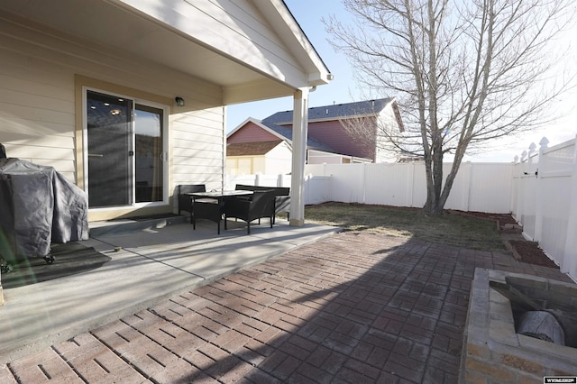 wooden deck featuring a fenced backyard and a patio area