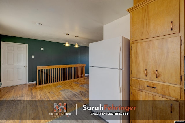 kitchen with freestanding refrigerator and hardwood / wood-style flooring