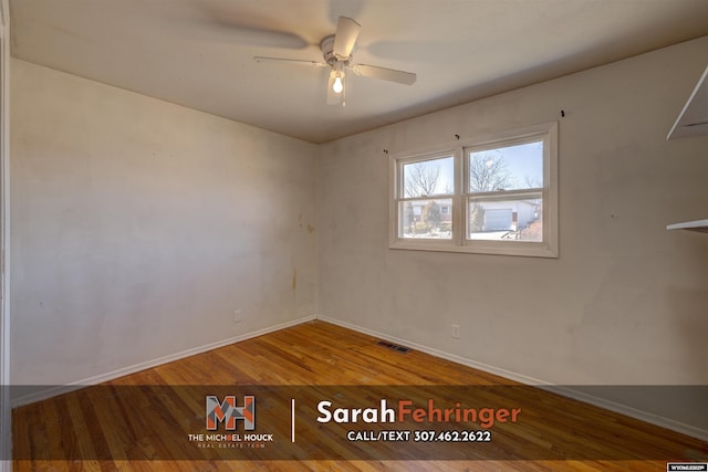 spare room featuring a ceiling fan, wood finished floors, visible vents, and baseboards