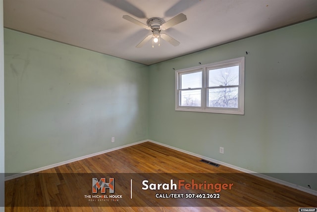 unfurnished room with visible vents, a ceiling fan, baseboards, and wood finished floors