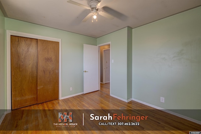 unfurnished bedroom featuring a closet, a ceiling fan, baseboards, and wood finished floors