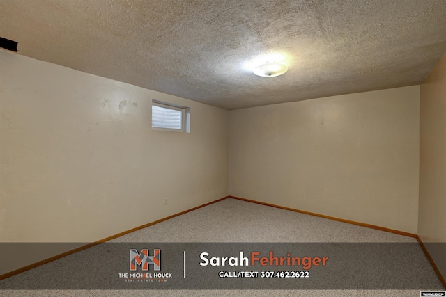 interior space with a textured ceiling and baseboards