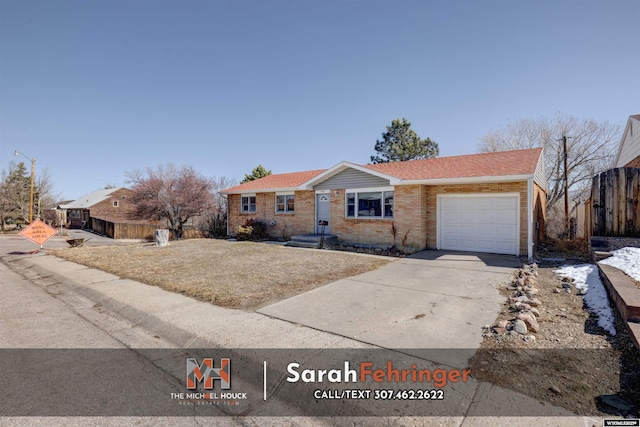 ranch-style house with brick siding, concrete driveway, an attached garage, and a shingled roof