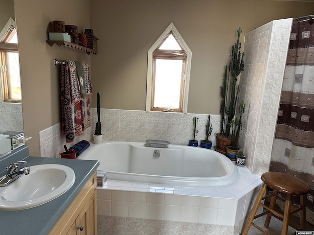 full bath with vanity, a garden tub, and a shower with curtain