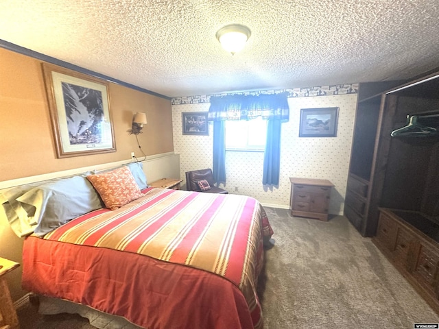 carpeted bedroom with baseboards, a textured ceiling, and wallpapered walls