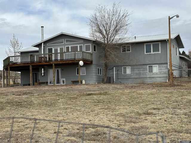 rear view of house featuring a wooden deck