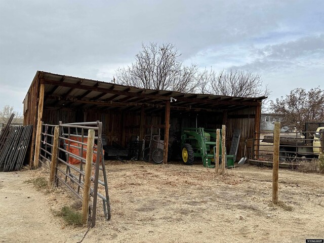 view of outbuilding featuring a carport and an outdoor structure