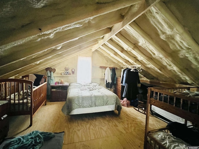 bedroom featuring wood finished floors and vaulted ceiling