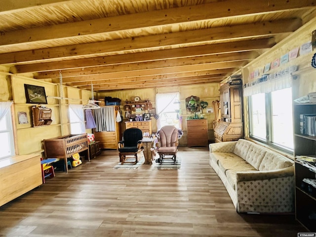 living area with beam ceiling, wooden ceiling, and wood finished floors