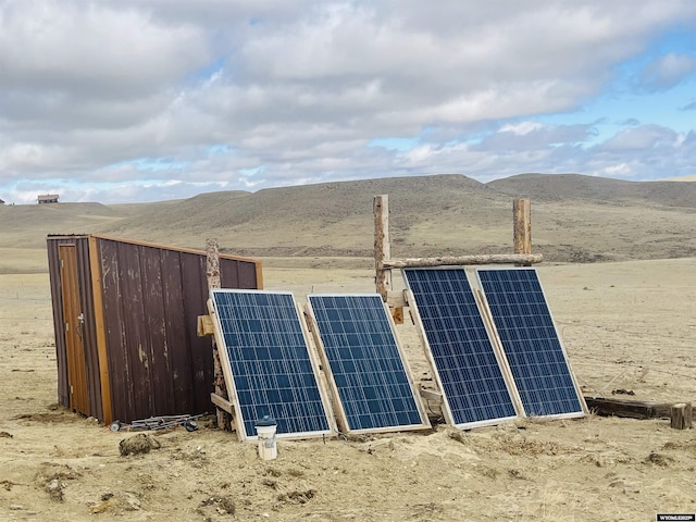 view of outbuilding with solar panels and a mountain view