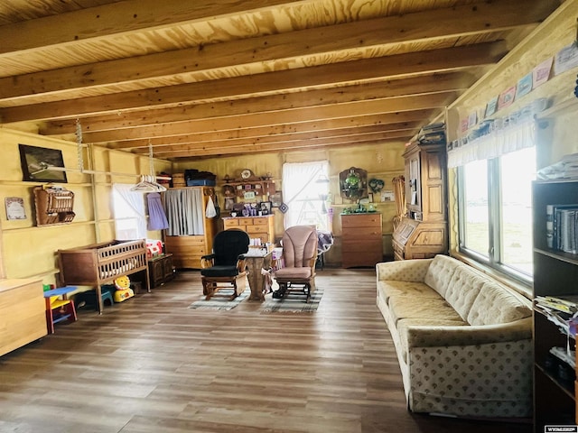 living area with beam ceiling, wood ceiling, and wood finished floors