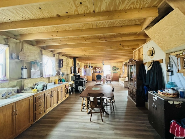 dining area with beam ceiling, wood ceiling, and dark wood-style flooring