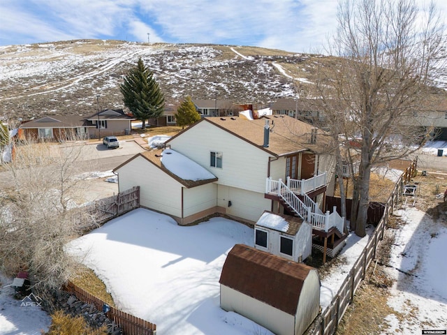 snowy aerial view featuring a mountain view