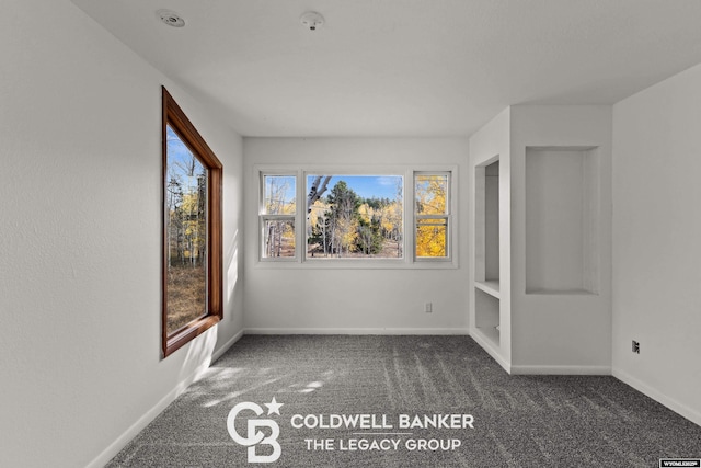 unfurnished room featuring baseboards and carpet