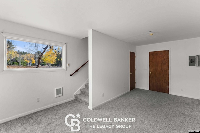 interior space featuring visible vents, baseboards, carpet, and stairs