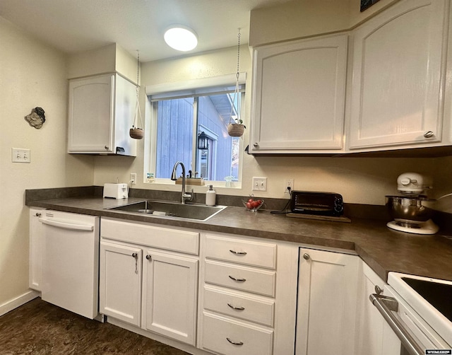 kitchen with a sink, dark countertops, white cabinets, white dishwasher, and stove