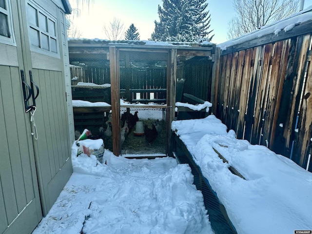 exterior space with an outbuilding, fence, and exterior structure