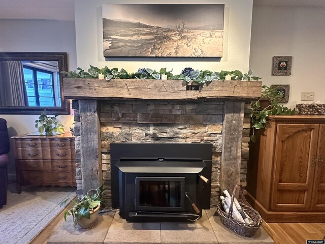 details with wood finished floors and a glass covered fireplace