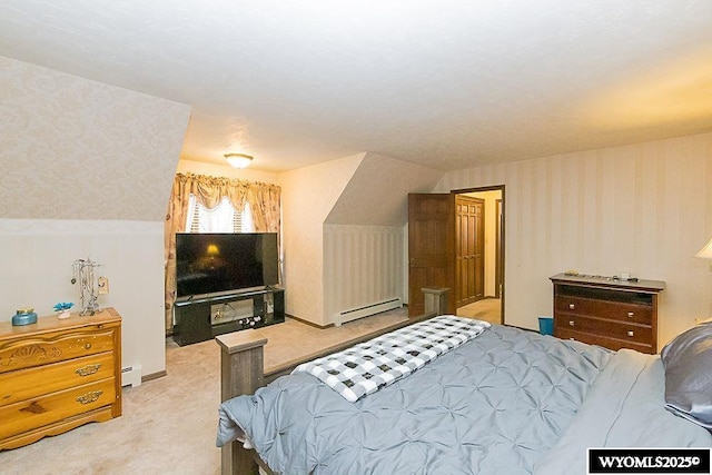 carpeted bedroom featuring a baseboard heating unit and wallpapered walls