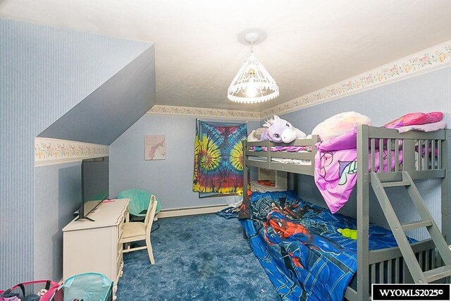 carpeted bedroom with wallpapered walls, a baseboard heating unit, and lofted ceiling