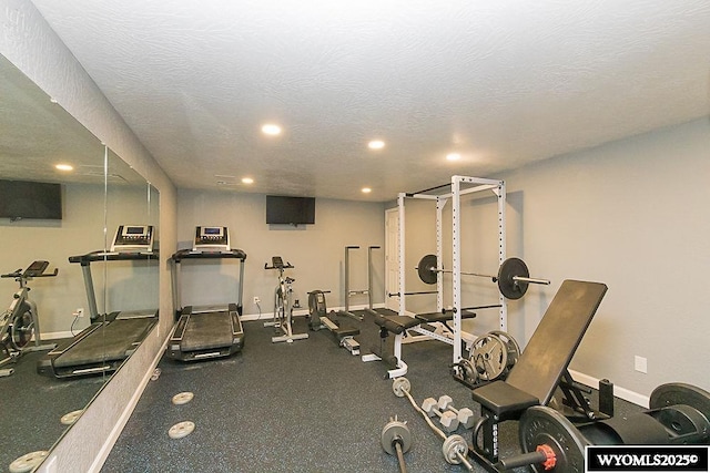 exercise room with recessed lighting, baseboards, and a textured ceiling