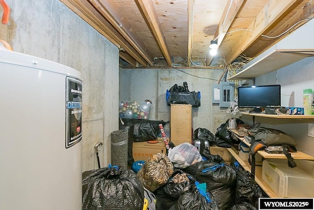 unfinished basement with electric panel and water heater