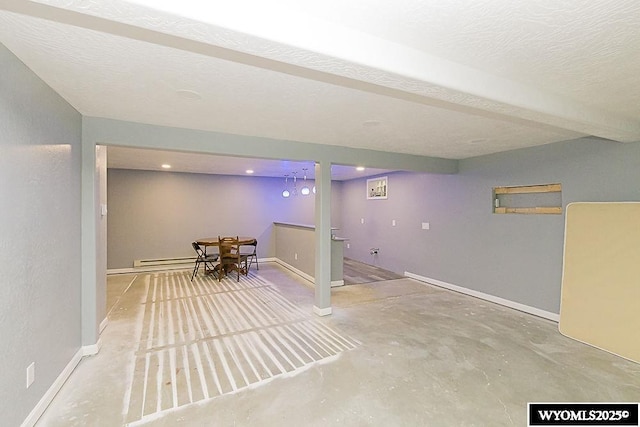 finished basement with a baseboard radiator, baseboards, and a textured ceiling