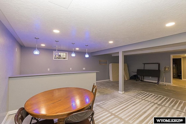 dining space with recessed lighting, a textured ceiling, and baseboards