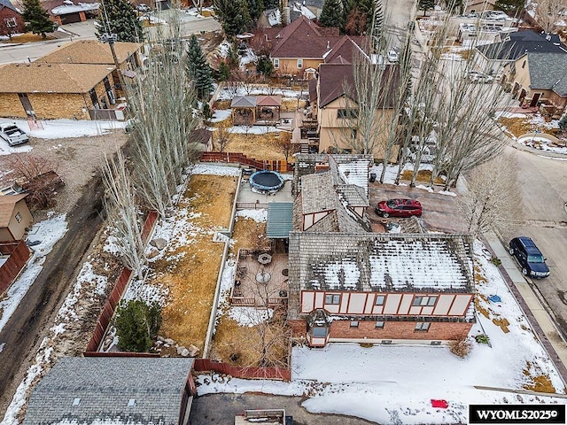 snowy aerial view with a residential view