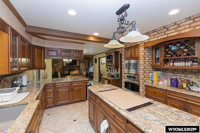 kitchen with beam ceiling, a sink, stainless steel appliances, glass insert cabinets, and light stone countertops