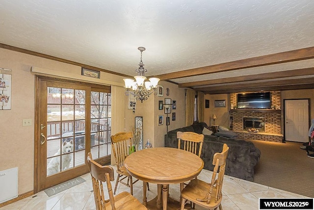 dining space with beam ceiling, a textured ceiling, an inviting chandelier, a fireplace, and light tile patterned floors