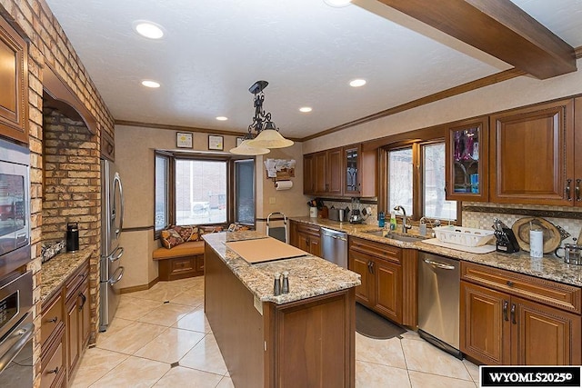 kitchen featuring a center island, glass insert cabinets, light tile patterned flooring, plenty of natural light, and stainless steel appliances