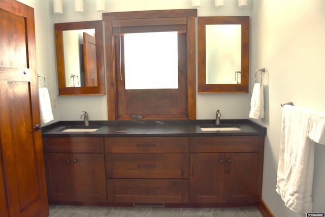 full bathroom with a sink, visible vents, and double vanity