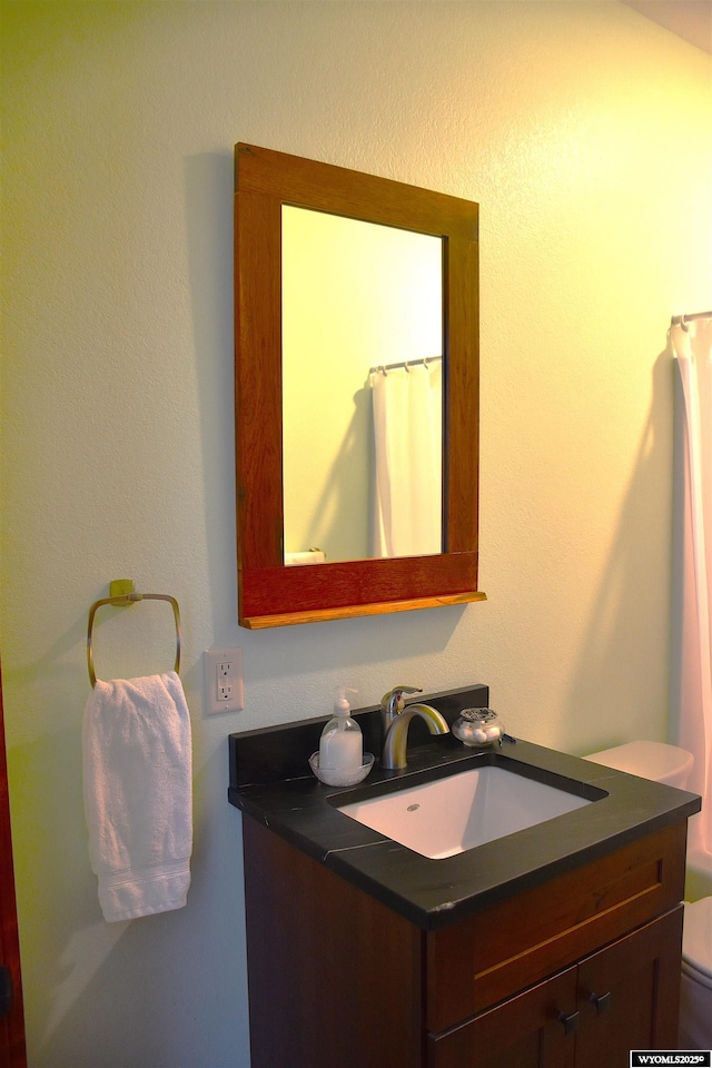 bathroom featuring vanity and toilet