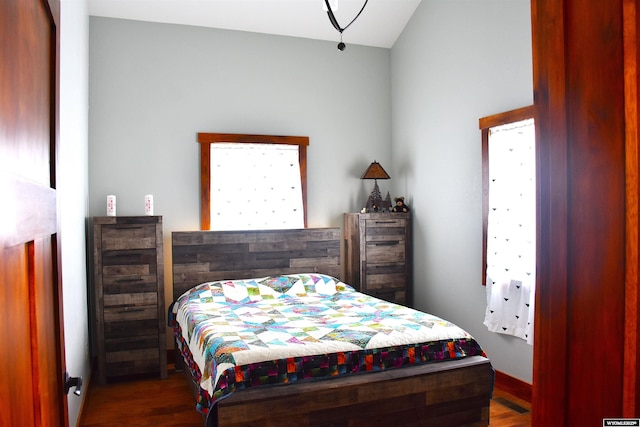 bedroom featuring dark wood-style flooring