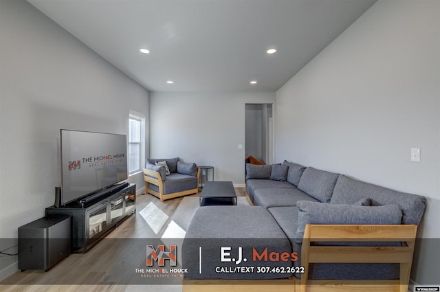 living area featuring recessed lighting, baseboards, and wood finished floors