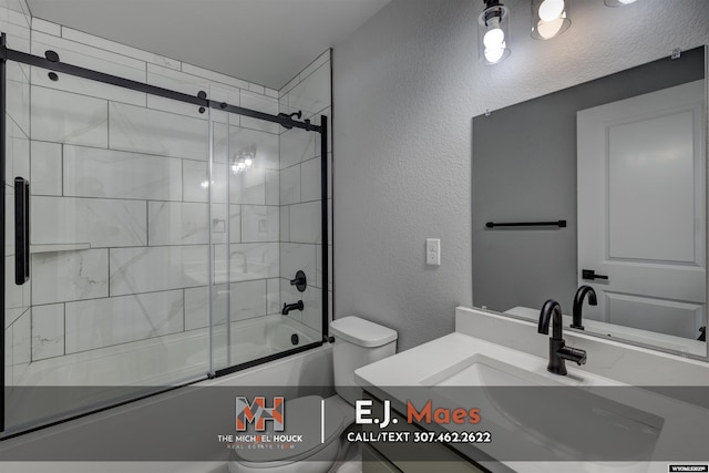 bathroom featuring enclosed tub / shower combo, toilet, vanity, and a textured wall