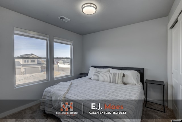 bedroom with carpet, visible vents, a closet, and baseboards